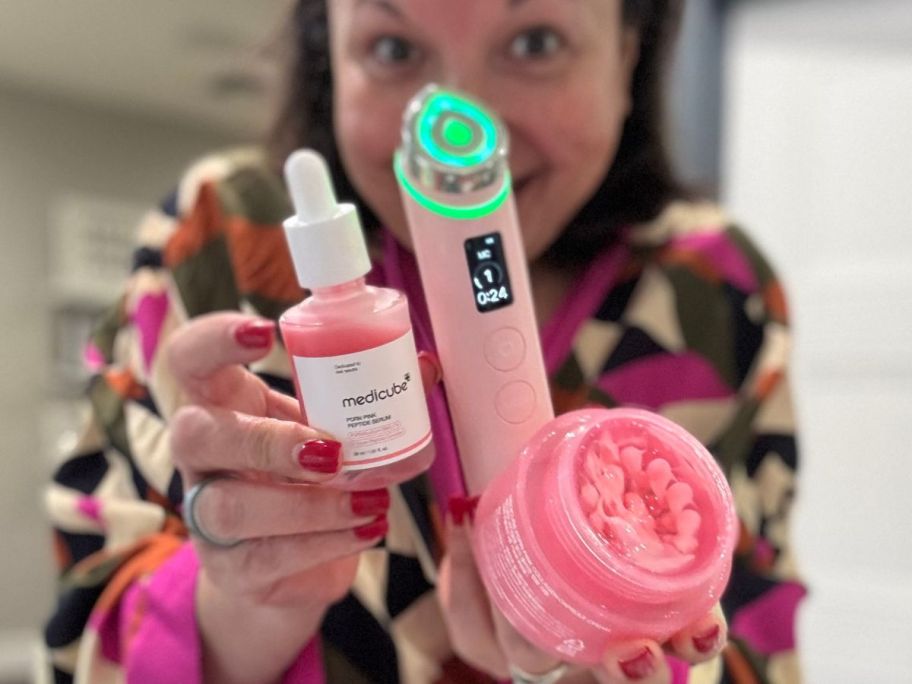 woman holding multiple medicube items