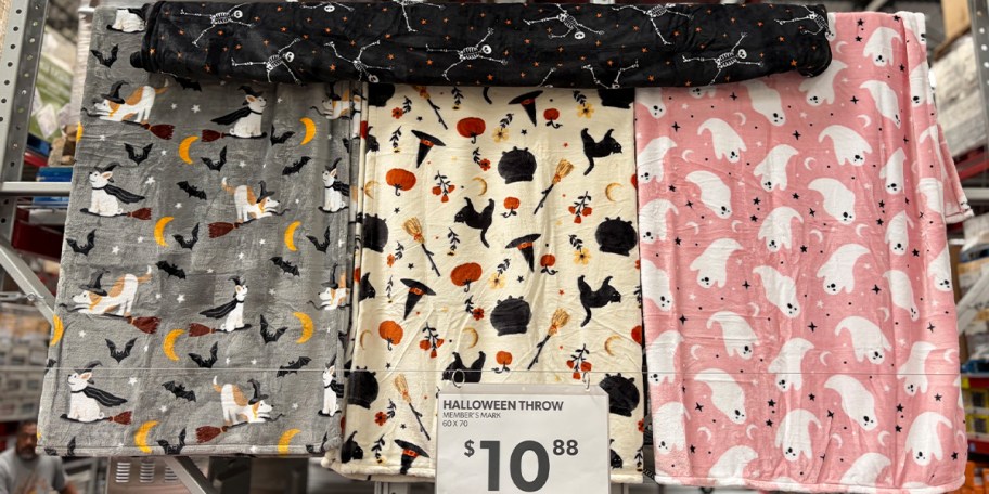 gray, white, and pink halloween blankets hanging 