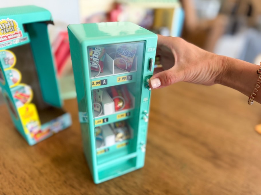 hand holding a Mini Brands toy vending machine