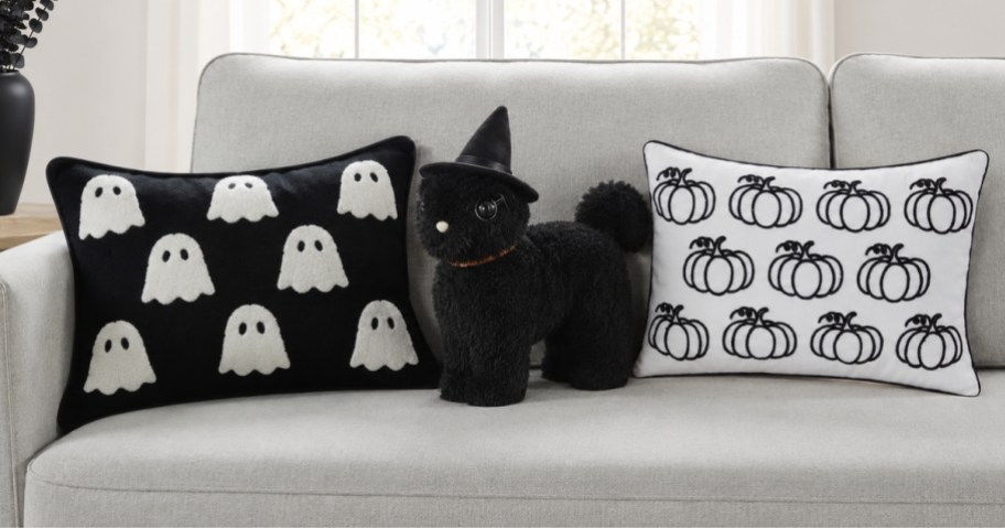 3 Halloween throw pillows on a sofa