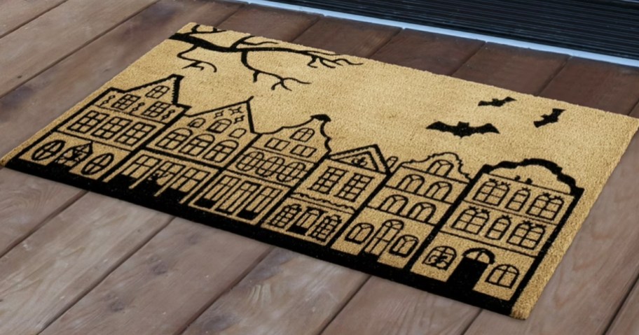 a haunted house Halloween doormat
