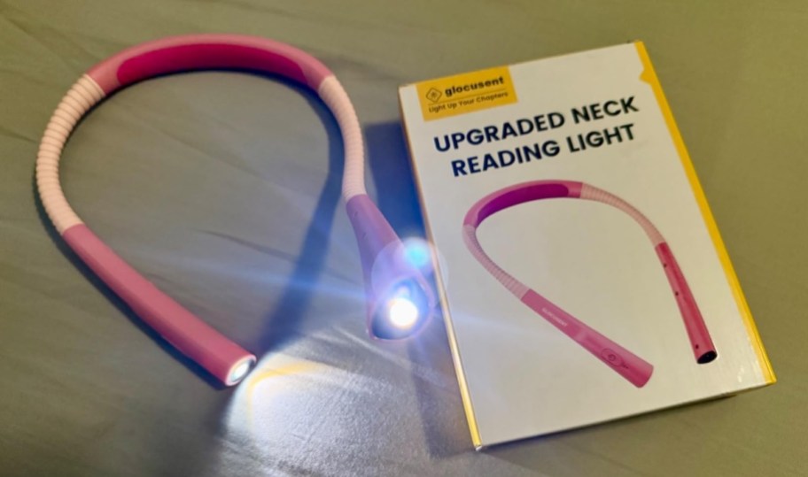 pink neck reading light on sheets