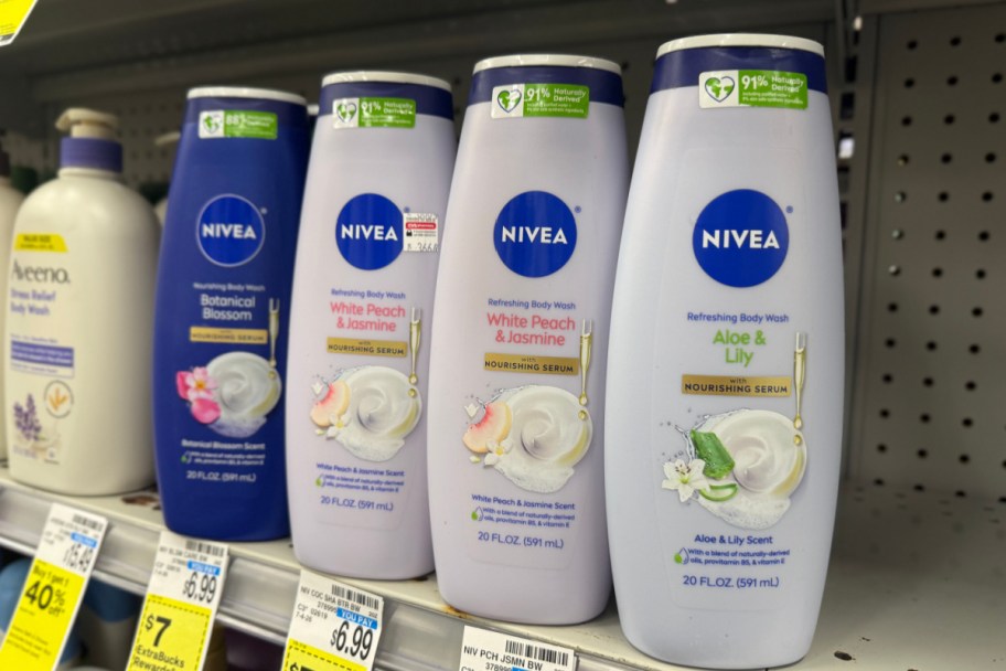 four purple bottles body wash on shelf in store
