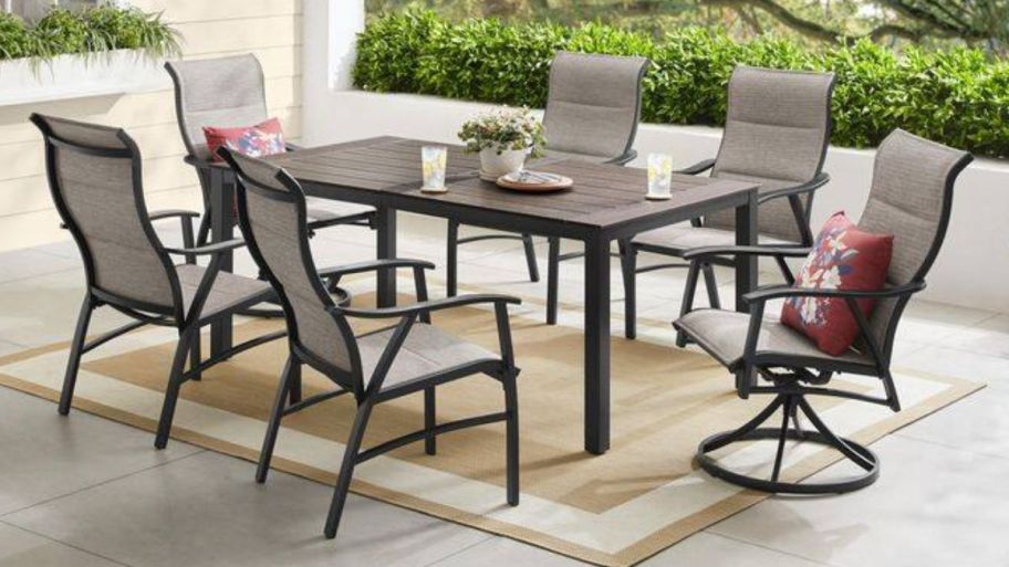 outdoor seating with table on top of a rug 