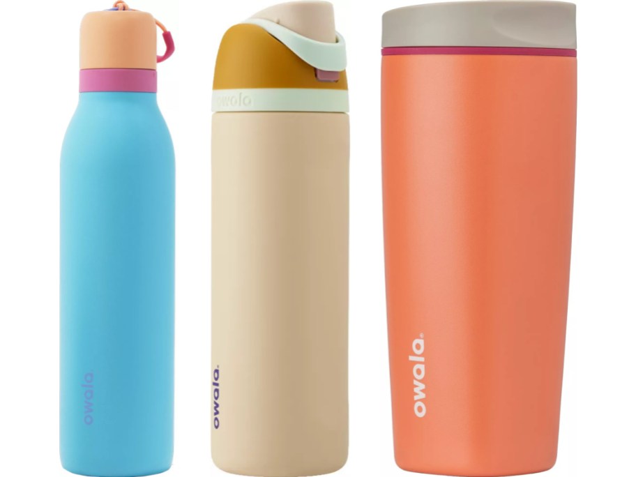 Three Owala drink containers against a white background: a bright blue water bottle with a peach and pink lid, a beige water bottle with a mustard yellow and mint green lid, and a coral tumbler with a light grey lid.