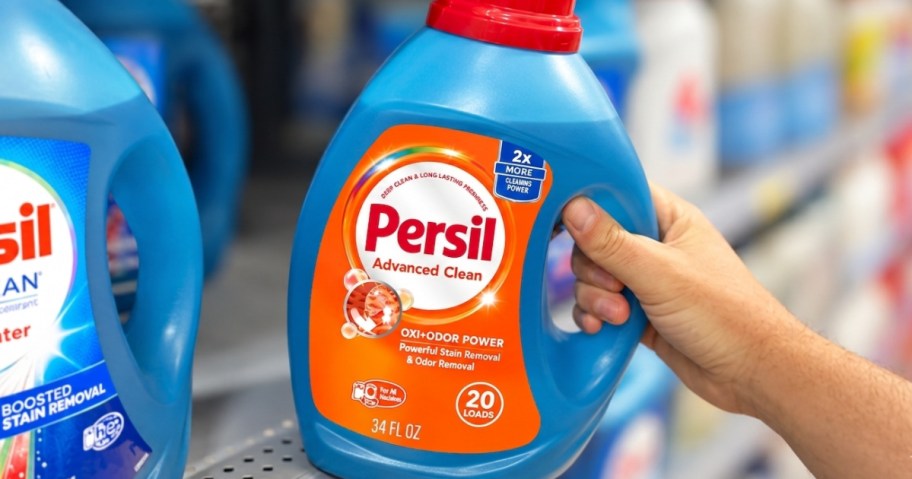hand holding laundry detergent in store