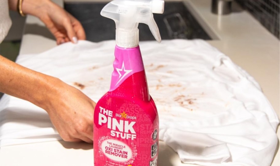 the pink stuff bottle on table with dirty tee 