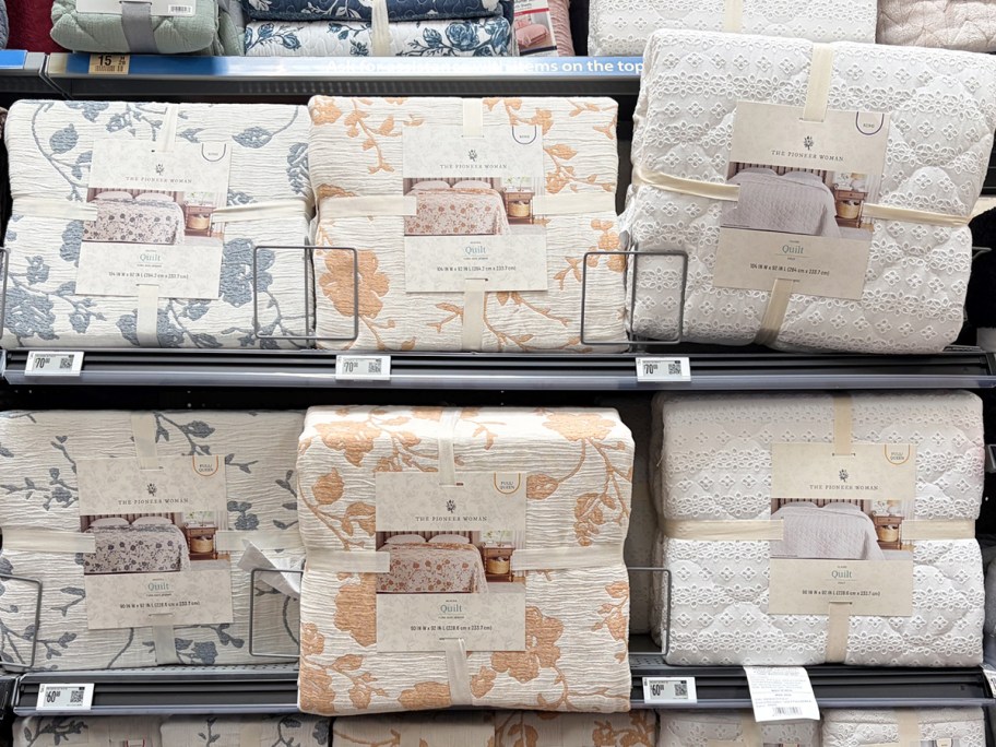 floral quilts on shelves in store