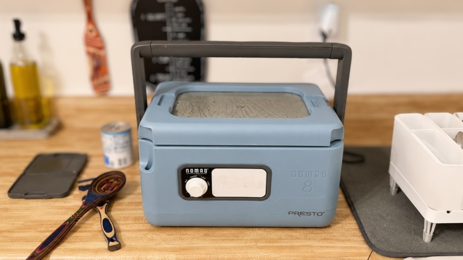 presto nomad 8qt slow cooker on a kitchen countertop in use