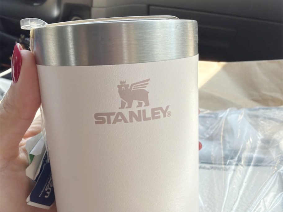 hand holding stanley white cup