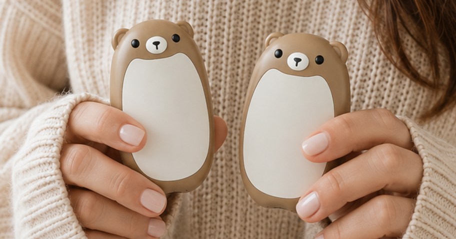 woman wearing a sweater holding bear hand warmers