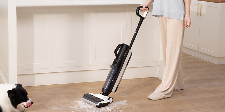 person using vacuum on spilled milk