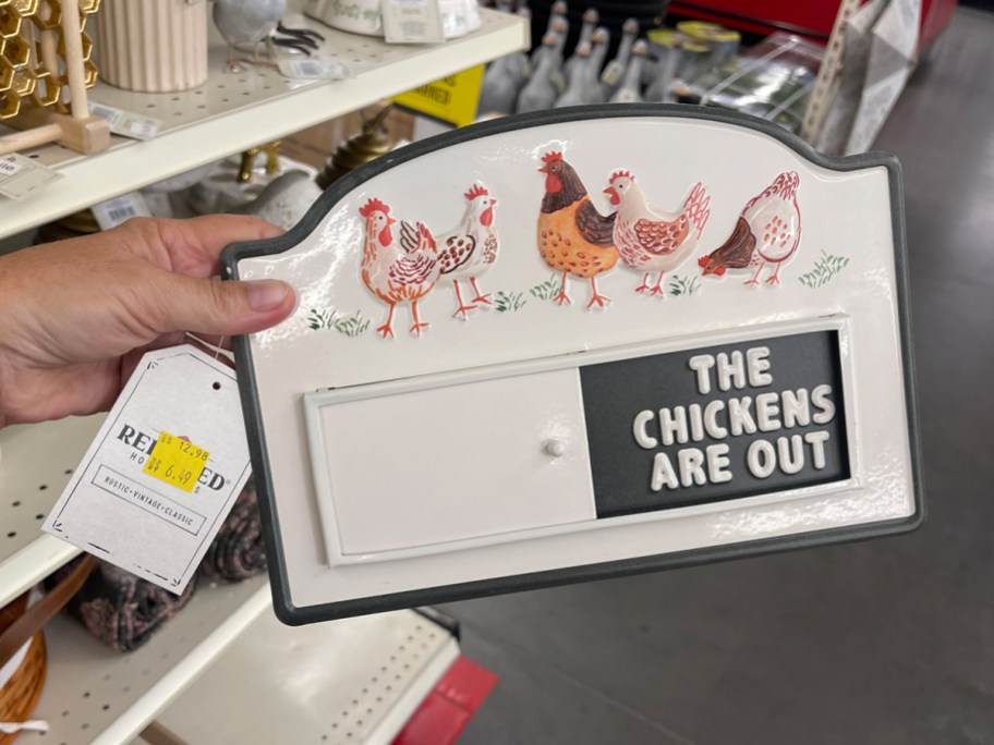 hand holding chicken sign