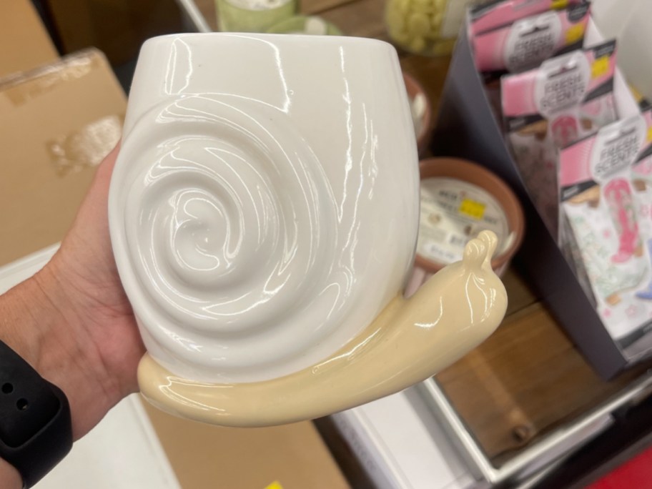 hand holding snail cup