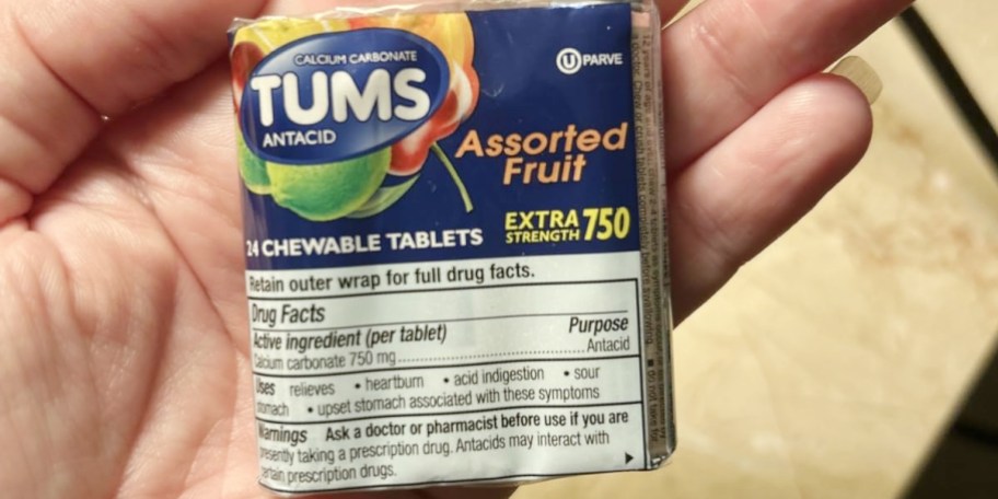 hand holding tums pack