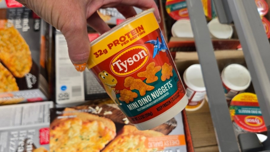hand holding a container of mini dino nuggets