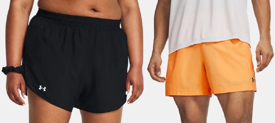 Two people wearing Under Armour athletic shorts: one in black and one in orange.
