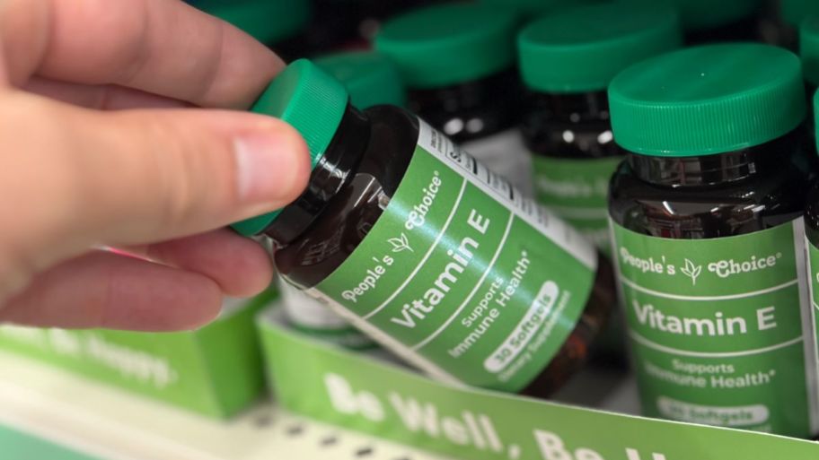 Hand holding dollar tree vitamin E