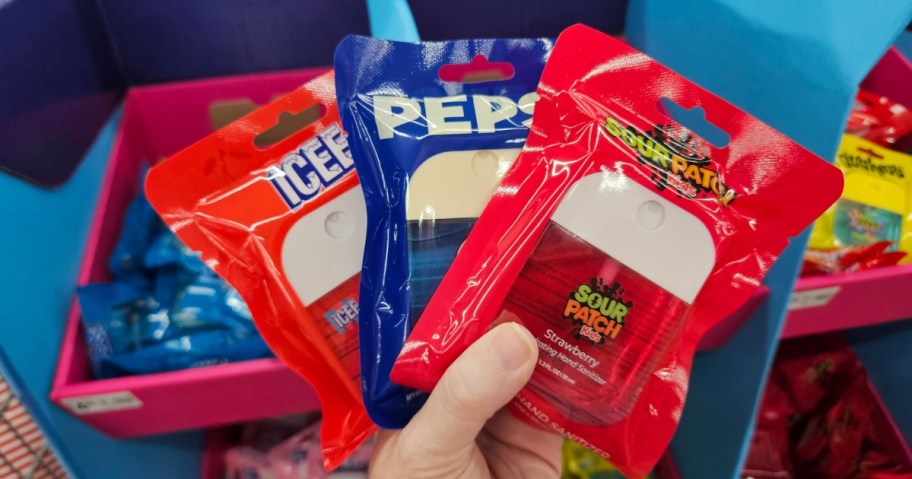 hand holding packs of drink and candy flavored hand sanitizers