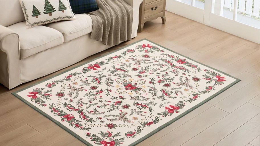 red white and green floral print rug in front of a sofa