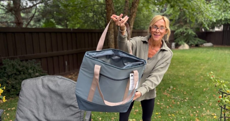 Woman opening cooler bag and smiling