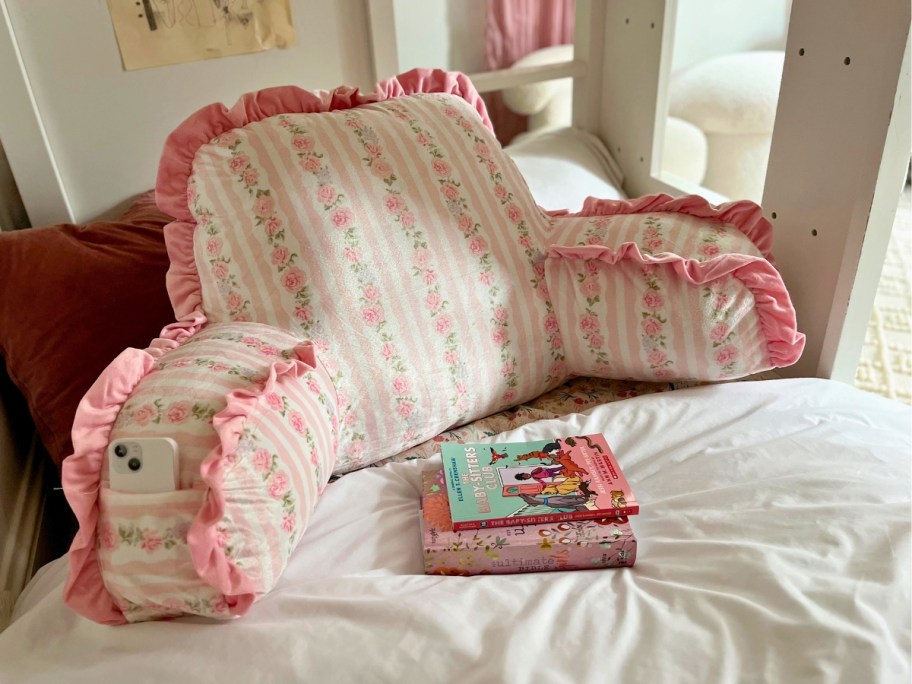 a floral backrest pillow on a bed
