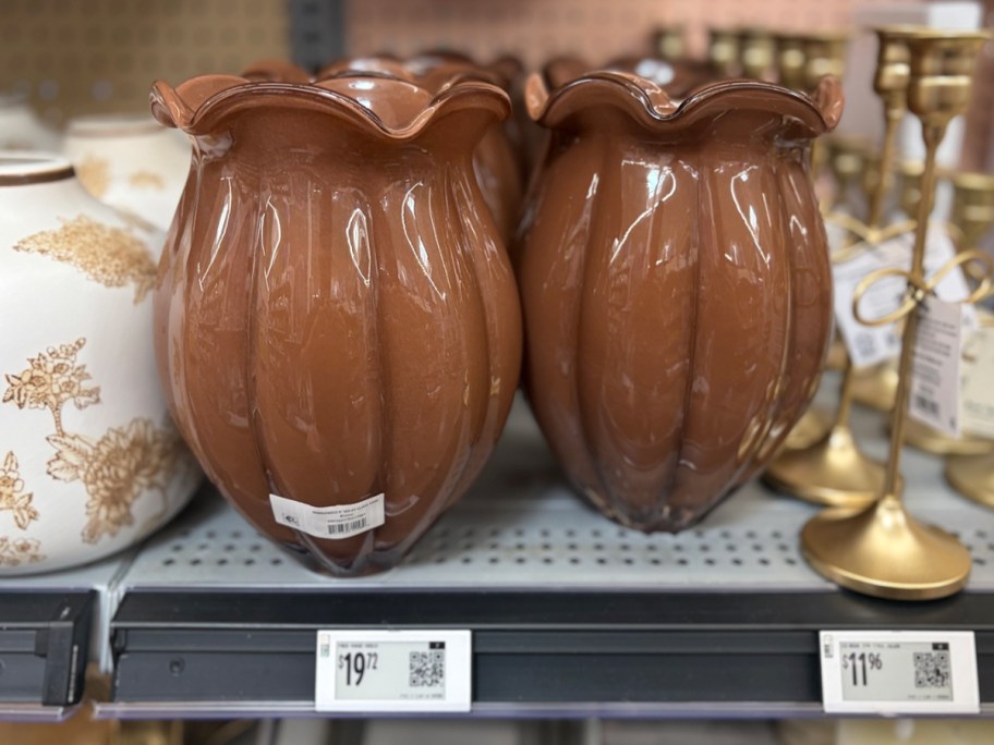two brown glass vases on shelf