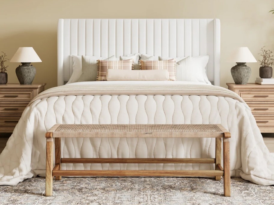 white platform bed with white bedding on top 