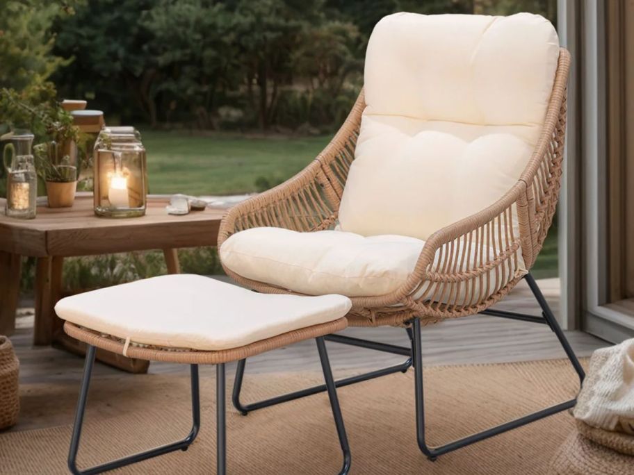 Outdoor wicker chair and ottoman with cushion displayed outside