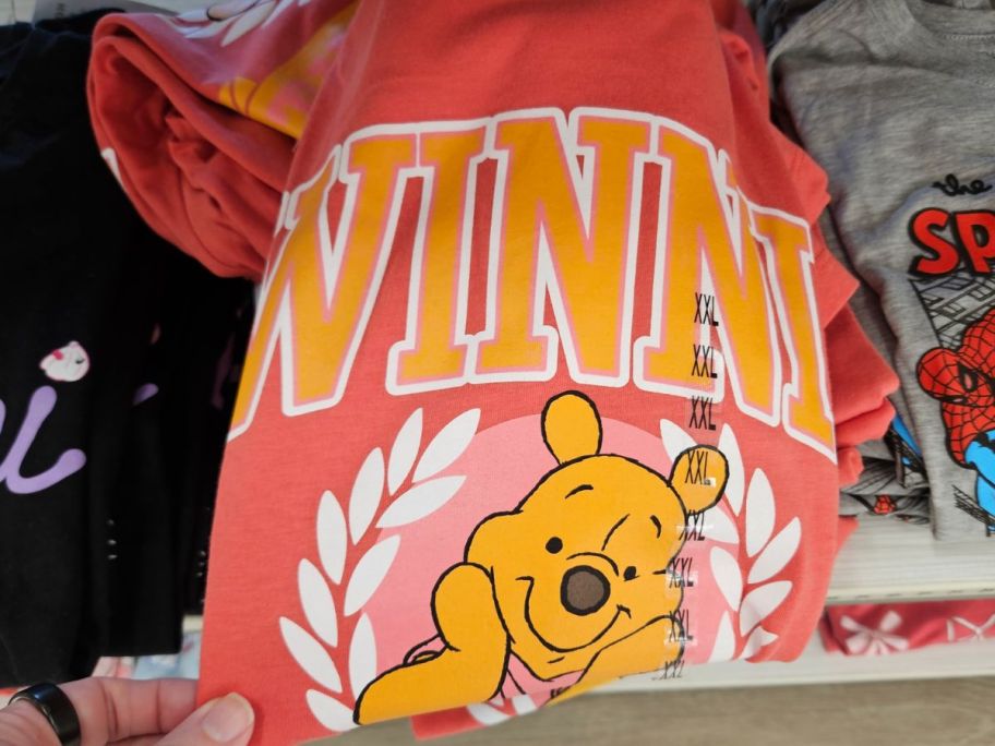 winnie the pooh with flowers graphic tee displayed at the store