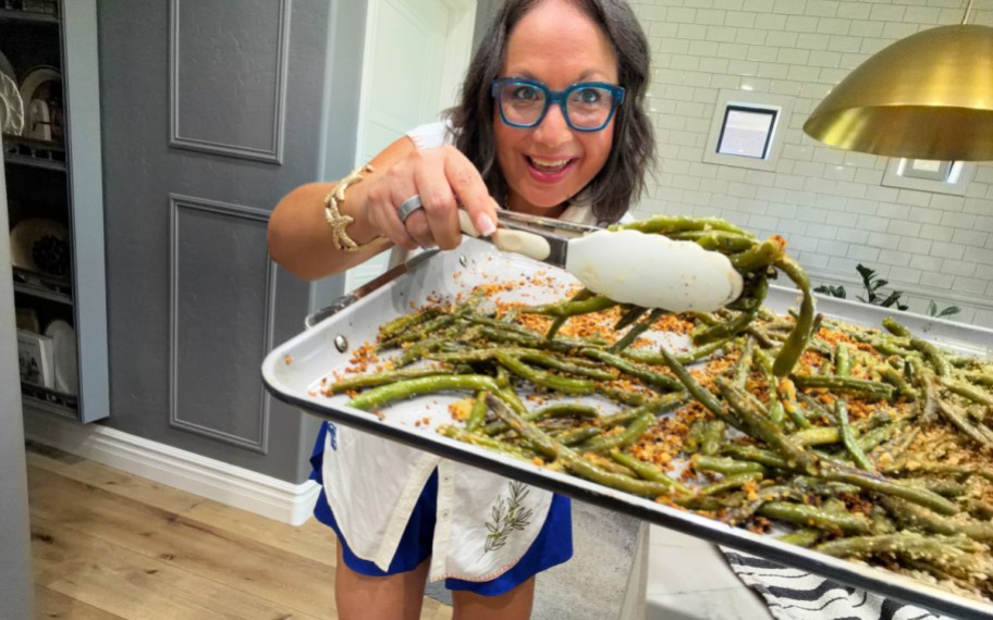 woman dishing up roasted frozen green beans