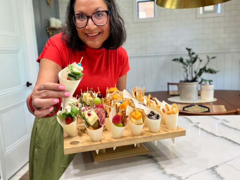 woman holding a charcuterie cone snack display 