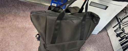 hand holding black All In Motion Faux Neoprene Tote Backpack