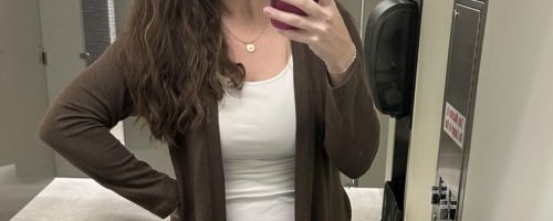 Woman wearing a brown and white cardigan sweater