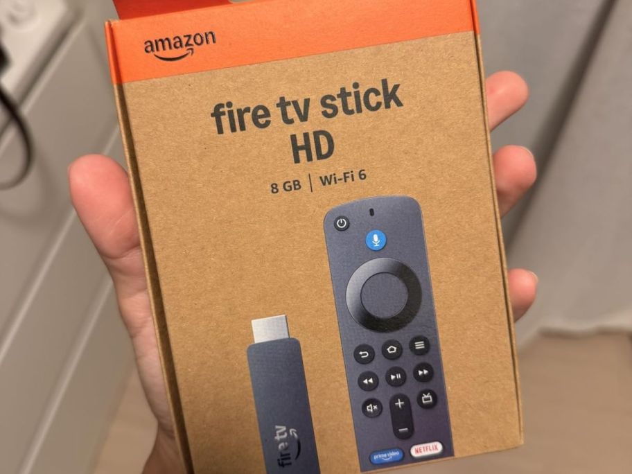 Hand holding an Amazon Fire TV HD Stick