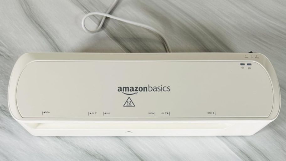 Amazon basic laminator on top of a marble table