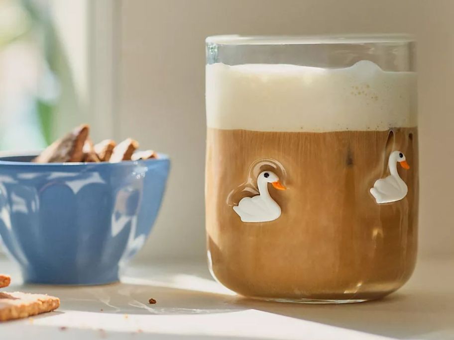 Anthropologie Icon Juice Glass with swans on it on table