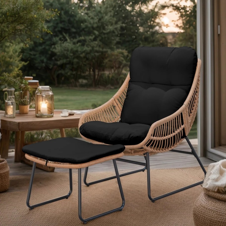 wicker chair and ottoman with black cushions