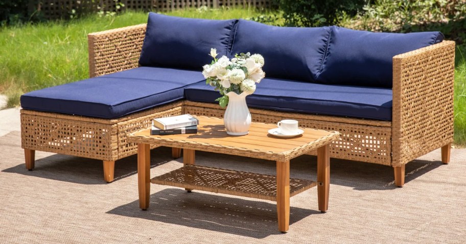 wicker sectional with blue cushions and coffee table