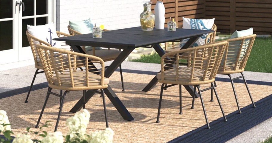 wicker patio dining chairs around a black rectangular table
