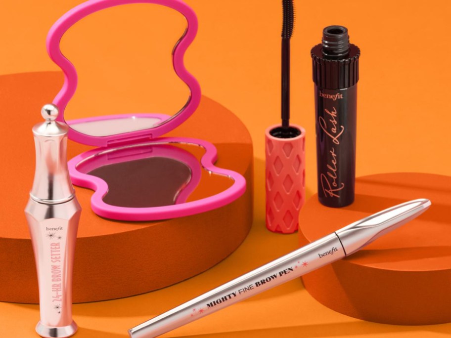 benefit mascara, brow pen, brow setter, and a pink mirror