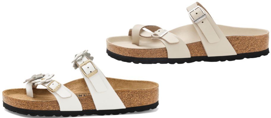 Two pairs of Birkenstock toe-loop sandals, featuring a white pair with flower-embellished straps on the bottom and a light cream pair on top.