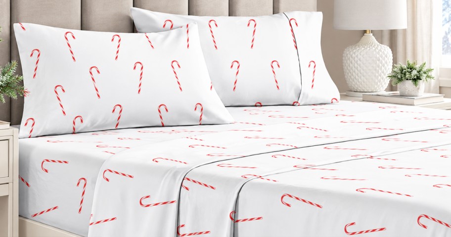 candy cane print sheets and pillowcases on a bed
