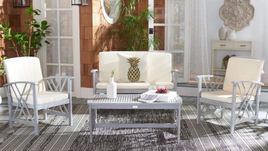 gray wooden patio set with white cushions