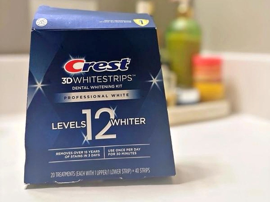 Crest 3D White Professional Effects Whitening Kit box displayed on a bathroom counter.