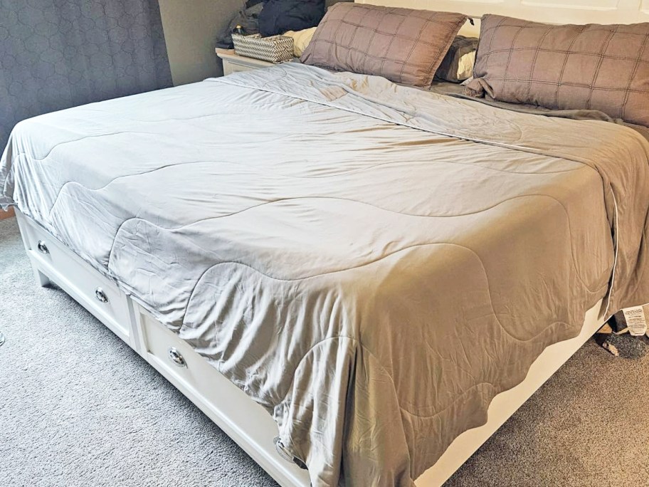 bed made with a grey cooling comforter on top