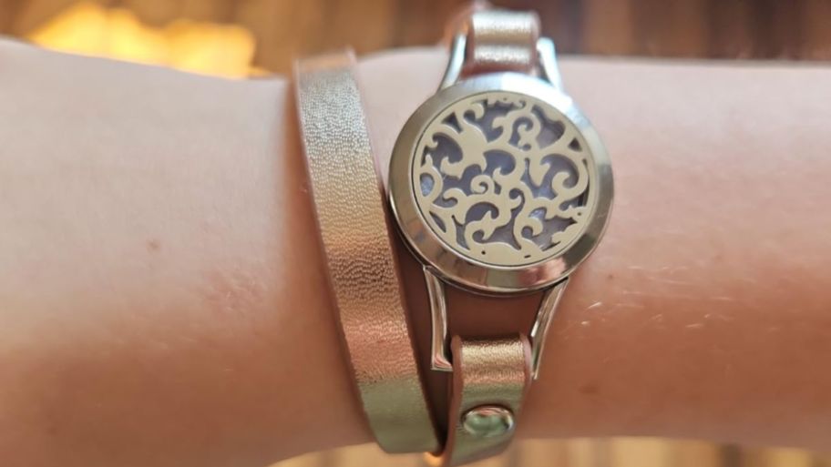 Arm wearing Diffuser bracelet in gold