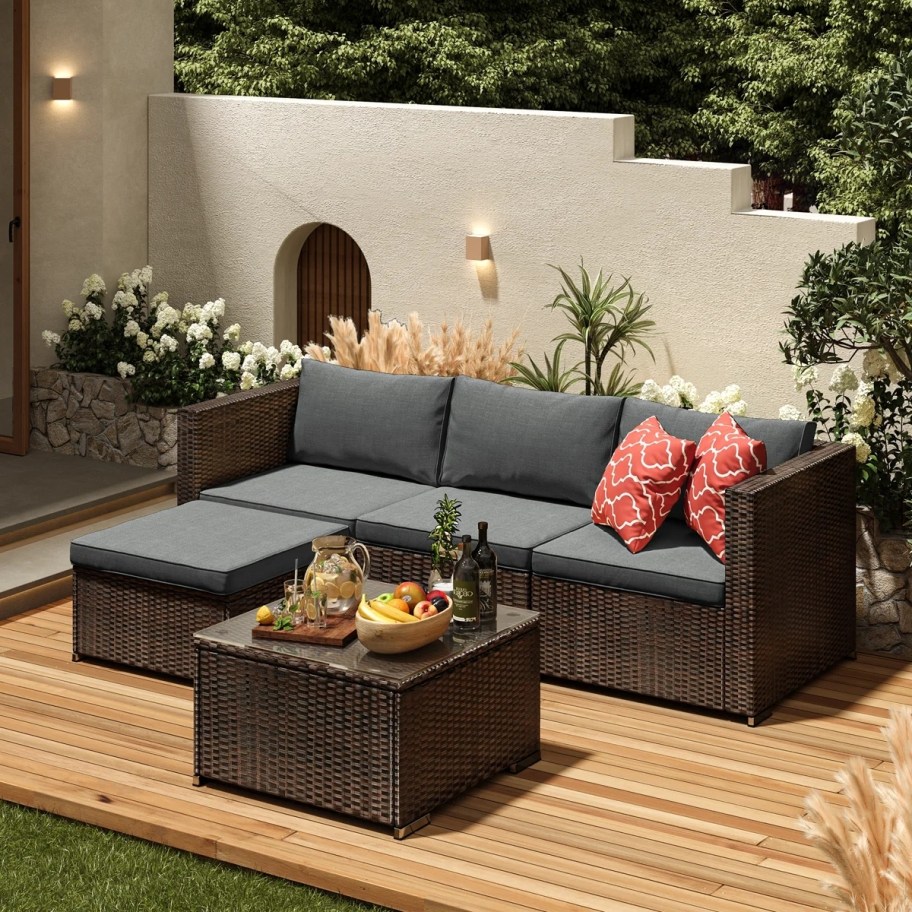 brown wicker outdoor sectional with gray cushions