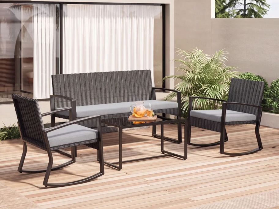 Ebern Designs Wicker 4-Person Patio Seating Set on patio