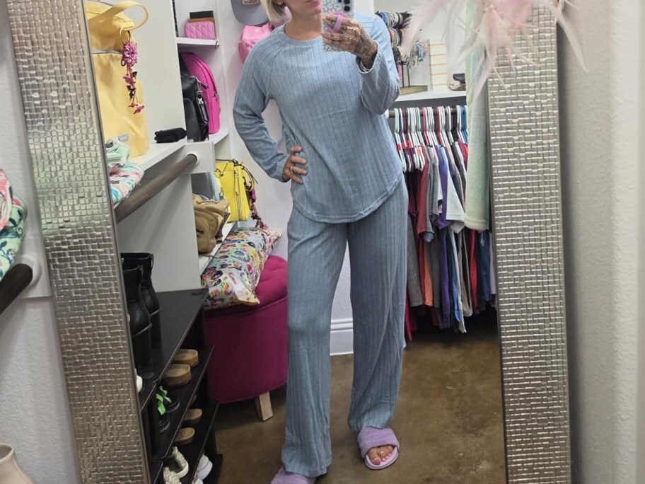 woman taking photo in a mirror wearing a matching blue lounge set